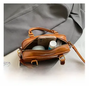 Detailed interior view of vintage brown leather bowling bag showing ample storage space