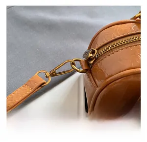 Detailed macro of vintage bronze metal hook and zipper on brown leather bowling bag