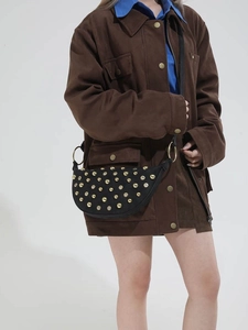 Black half-moon shoulder bag with gold metal studs and rivets, vintage rock style design