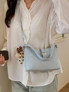 Light blue faux leather crossbody bag with cute bear charm and adjustable strap for women
