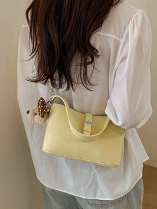 Pale yellow hobo bag in wrinkled faux leather with plush puppy charm for women