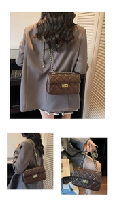 Detail of dark brown quilted leather crossbody bag with gold hardware and chain strap