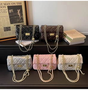 Quilted chain bags in black, brown, silver, pink, and white on a stylish display