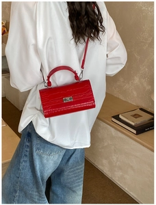 Red crocodile pattern leather handbag shown worn as a crossbody bag on white shirt model