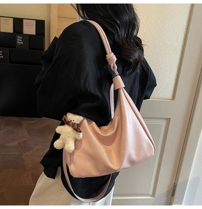 Pink PU leather hobo bag with knotted strap and cute plush bear charm detail