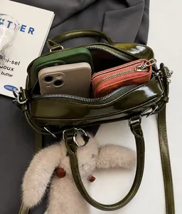Deep green patent leather Boston bag interior showing spacious room with a cute bunny charm