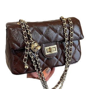 Classic dark brown quilted leather crossbody bag with gold chain and metal lock closure