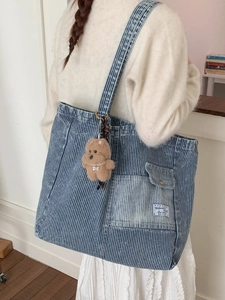 Large blue striped denim tote bag with front pocket and plush bear pendant for women