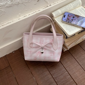 Pink sweet girl style tote bag with cute cat prints and bow decoration in a lifestyle setting