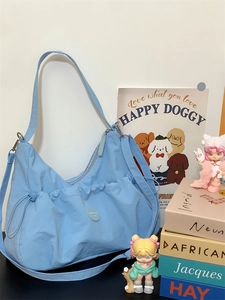 Détail du sac fourre-tout en nylon bleu ciel avec poche à cordon et bandoulière réglable