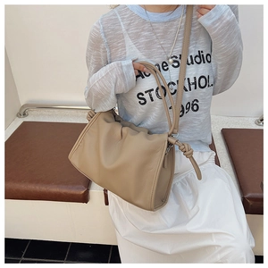Beige pleated dumpling shoulder bag with knotted strap and soft leather design