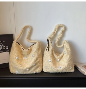 Detailed view of plush beige tote bags featuring soft 3D star accents and woven labels