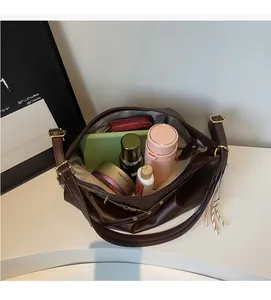 Spacious interior of retro brown leather tote bag with compartments for tablet and water bottle