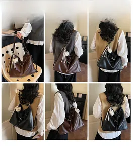 Detail view of large tote bags in coffee and black with cute bear charms on a model