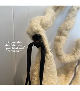 Detail of plush off-white shoulder bag featuring an adjustable black drawstring strap