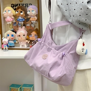Détail du sac cabas en tissu lavande avec poche à cordon et charm ours en peluche