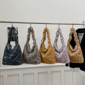 Detailed view of five faux fur shoulder bags in leopard print and solid neutral tones