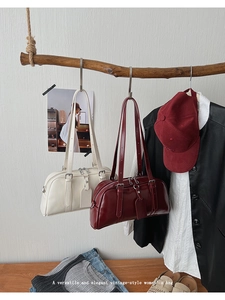 Detail of vintage women's bowling bags in cream and burgundy with silver hardware and straps