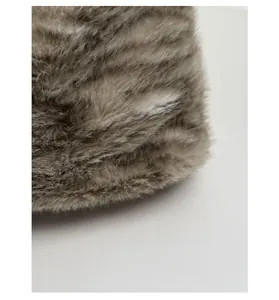 Close-up of soft grey leopard faux fur fabric showing thick texture and plush material
