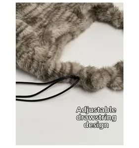 Detail of plush leopard bag with adjustable drawstring closure for shoulder carrying