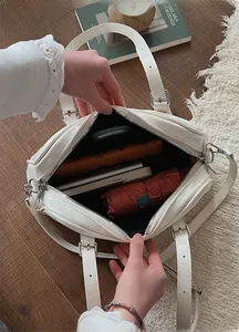 Interior view showing large capacity for umbrella, phone, and wallet in white leather bag