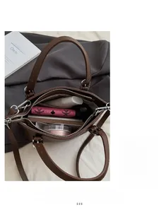 Top view showing the spacious interior compartments of the dark brown leather bucket bag