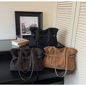 Three large tote bags in black, dark brown, and tan with white contrast stitching detail