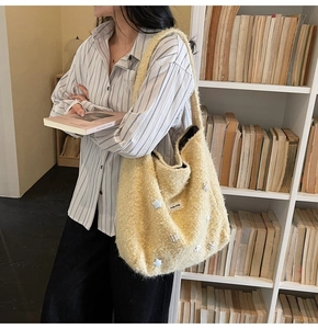 Detailed close-up of a plush beige tote bag with star patches in a cozy library setting