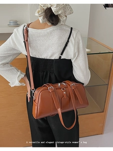 Brown leather vintage pillow bag worn by model showing casual over-the-shoulder style