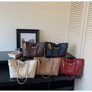 Detail view of large tote bags in five colors with beads tassel and metallic buckle