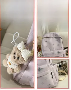 Detail view of lavender school backpack featuring butterfly prints and a plush bear charm