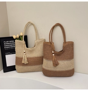 Detail of color-block woven straw tote bags with wooden bead tassels and texture