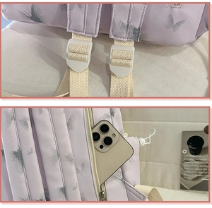 Close-up of reinforced stitching and side zip pocket for phone on purple nylon backpack