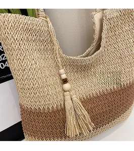 Detailed close-up of woven straw bag texture with decorative wooden bead tassel