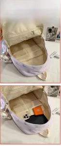 Internal view of nylon school backpack featuring multiple storage compartments and padded layers