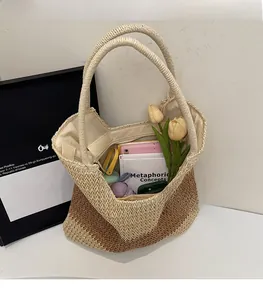 Detailed close-up showing the spacious interior and V-shape woven texture of the straw tote bag