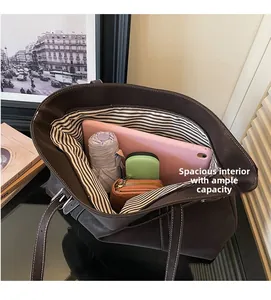 Detail of brown tote bag showing striped lining and large capacity for daily essentials