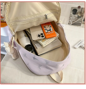 Detail view of large capacity nylon backpack interior with books and mesh compartment