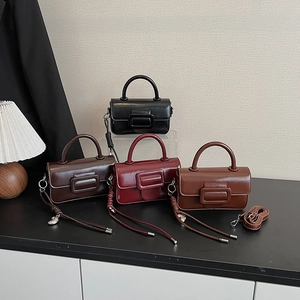 Detail showing four vintage glossy square bags in black, coffee, burgundy and brown