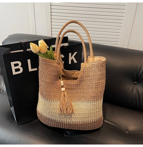 Detail view of woven beach bag showing three-color gradient texture and fringe tassel