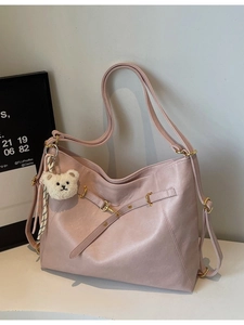 Vintage pale pink tote backpack for women with gold buckles and plush bear charm