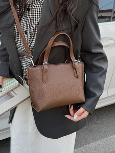 Classic brown pebble leather bucket bag for women with adjustable shoulder strap