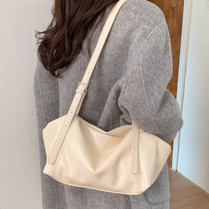 Cream vintage oversized tote bag on model shoulder showing casual drape and soft texture
