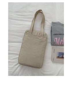 Detailed top view of beige quilted nylon handbag with vertical stripes and pockets