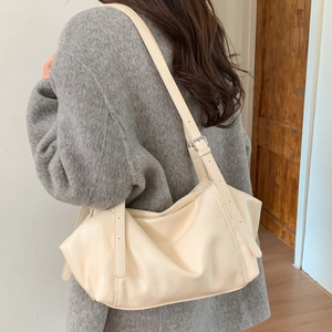 Detailed back view of cream-white soft leather shoulder bag with adjustable silver buckle