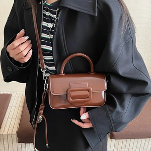 Deep brown glossy crossbody bag shown with chic outfit for elegant daily style