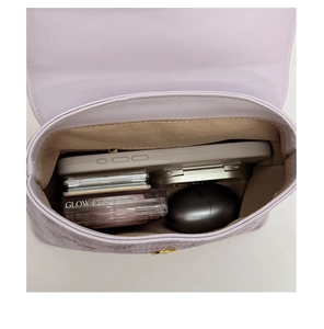 Spacious interior of lavender square bag showing main compartment with essentials