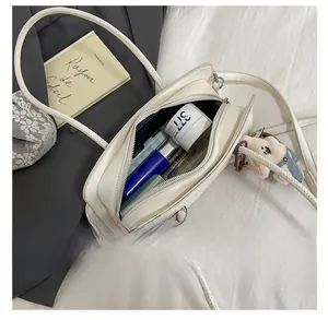 Interior view showing the large capacity of the creamy white tote bag with accessories