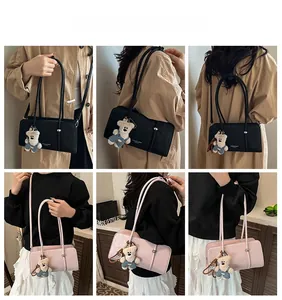 Detailed views of leather shoulder bag featuring cute bear plush charm and dual strap design