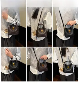 Detail showing versatile styling of leather bucket bags with gold rotating metal clasps